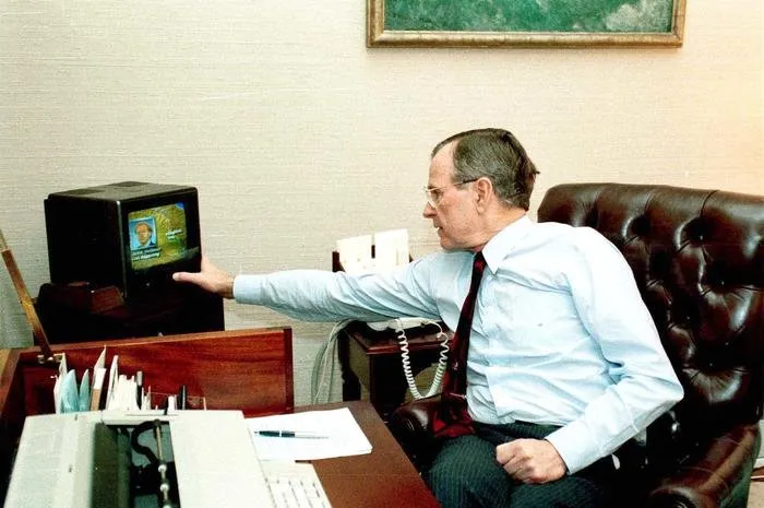 President Bush watches TV coverage of the commencement of Operation Desert Storm in the Oval Office Study