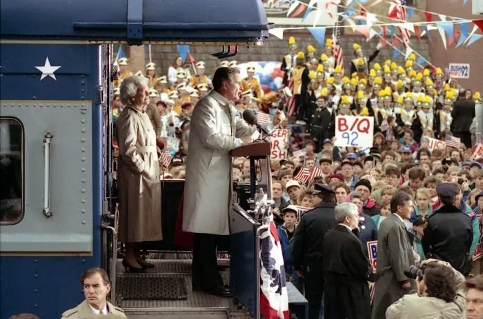 President Bush addresses supporters in Oshkosh, WI as Barbara Bush Looks On