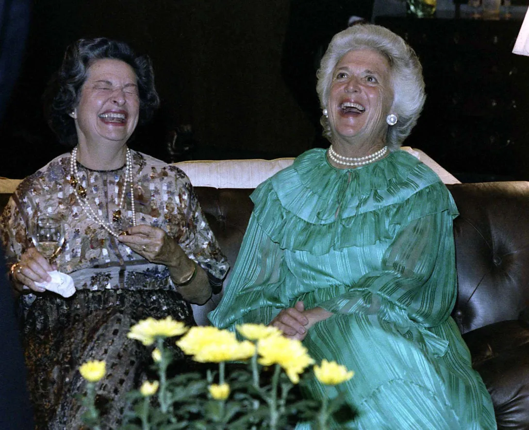 Mrs. Bush and Lady Bird Johnson, former First Lady, share a laugh at an event to celebrate the Dedication of the Gerald R. Ford Library in Grand Rapids, Michigan