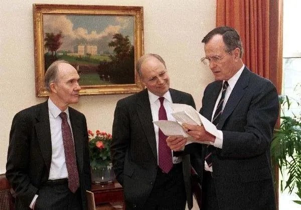 President Bush looks at papers with Sec. Cheney and Gen. Scowcroft