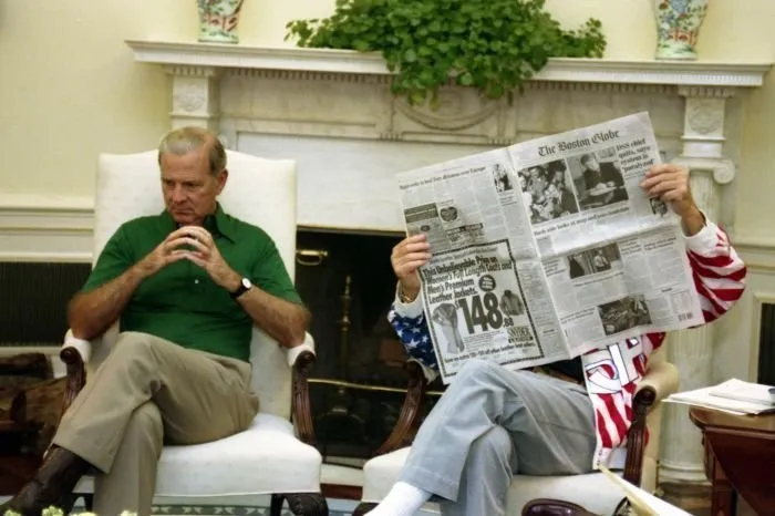 President Bush reads the Boston Globe before a debate breifing in the Oval Office