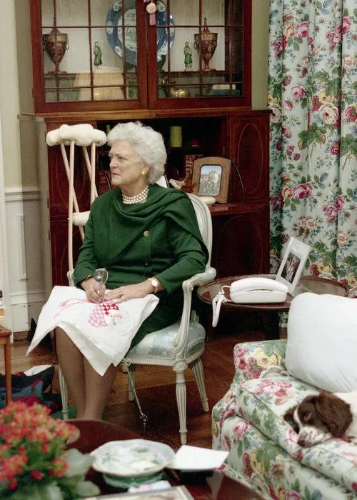 Mrs. Bush watches President Bush’s speech gives to the nation regarding the commencement of Operation Desert Storm, as she works on needlepoint in the White House Residence