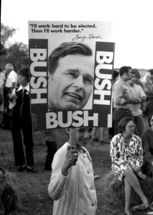 Child Holds a Bush Campaign Poster
