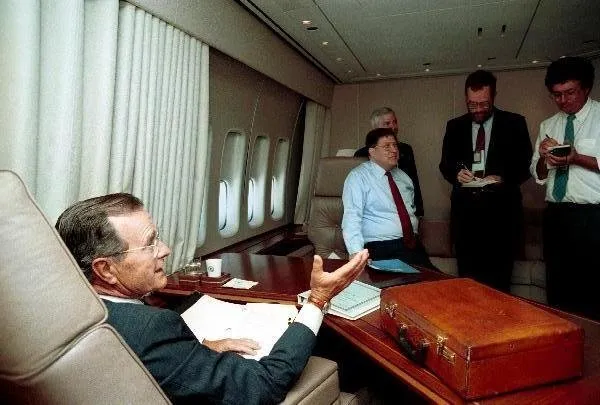 President Bush visits with members of the press on Air Force One