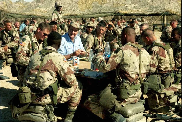 President Bush eating Thanksgiving dinner with troops in Saudi Arabia