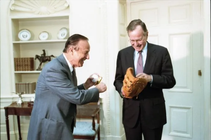 Stan Musial give President Bush an autographed glove and President Bush gives him an autographed baseball