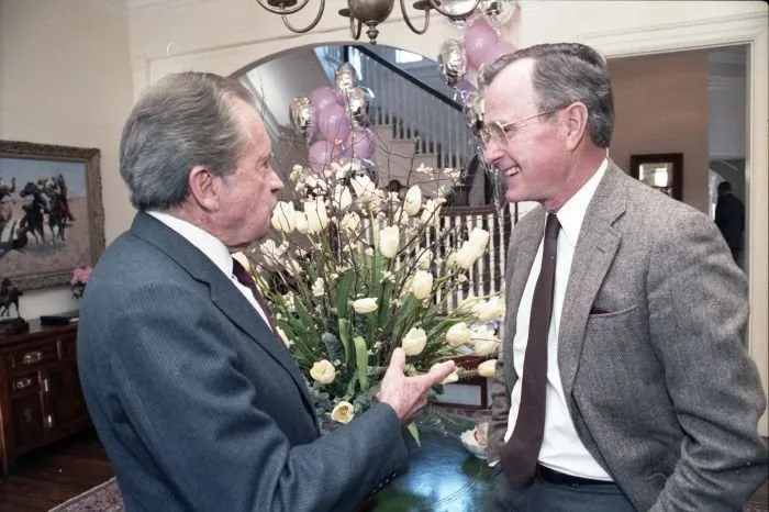Vice President George Bush chats with former President Richard Nixon at a party for former special counsel to President Nixon, Dick Moore, held at the Vice President's Residence