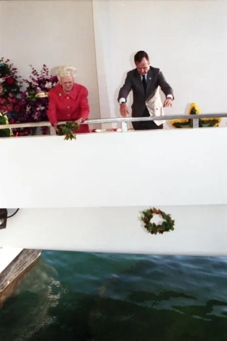 President and Mrs. Bush drop wreathes into the water from the aft of the USS Arizona Memorial as part of a ceremony commemorating the 50th anniversary of the Japanese attack on Pearl Harbor.
