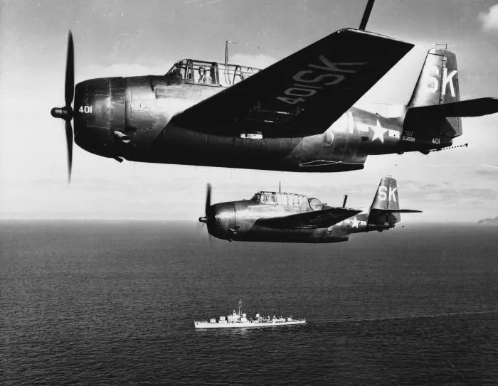 Two Avengers in flight with ship in background