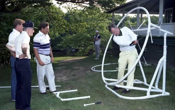 President Bush practices his swing while golfing at Cape Arundel Golf Club