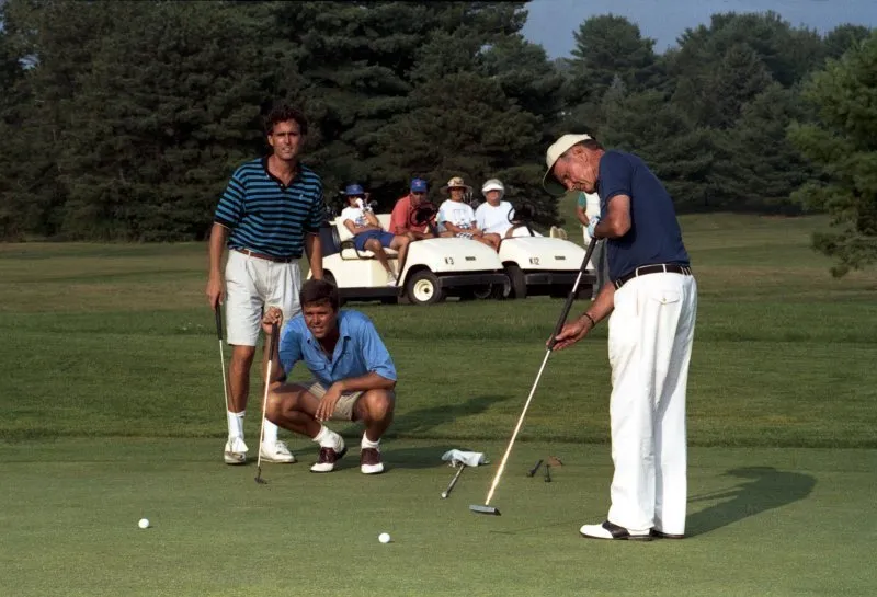 President Bush golfs with Jeb and Marvin