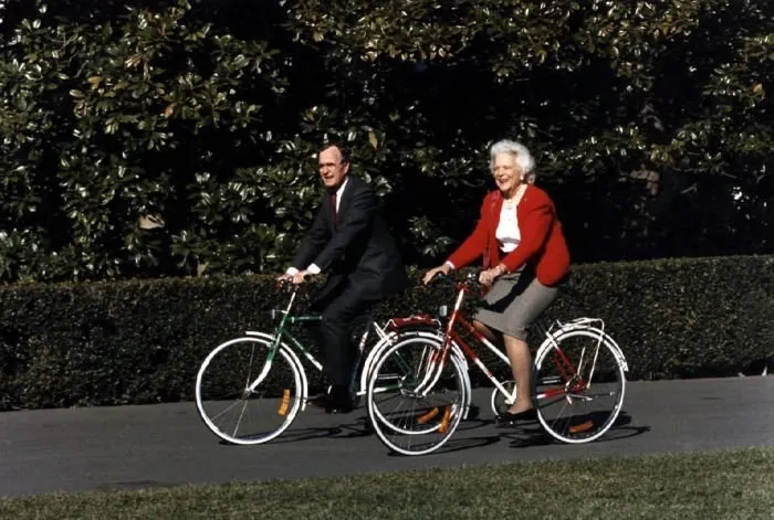 President Bush and Barbara Bush ride bicycles given to them by the Chinese on the South Grounds of the White House