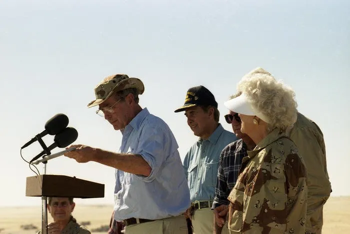 President and Mrs. Bush visit troops from the U.S. Army 197th Brigade, present horseshoes, and have Thanksgiving dinner