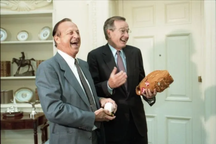 Stan Musial give President Bush an autographed glove and President Bush gives him an autographed baseball
