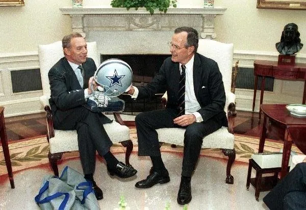 Jerry Jones presents President Bush with Cowboys helmet