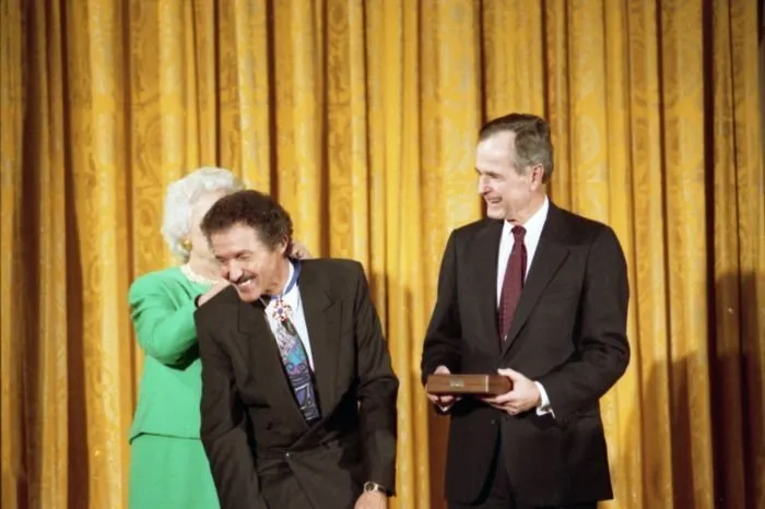 President and Mrs Bush award the Presidential Medal of Freedom to Nascar driver Richard Petty. Mrs Bush places the Medal around his neck.
