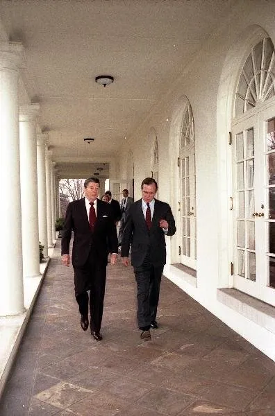 President Ronald Reagan and Vice President George Bush walk along the West Wing Colonnade