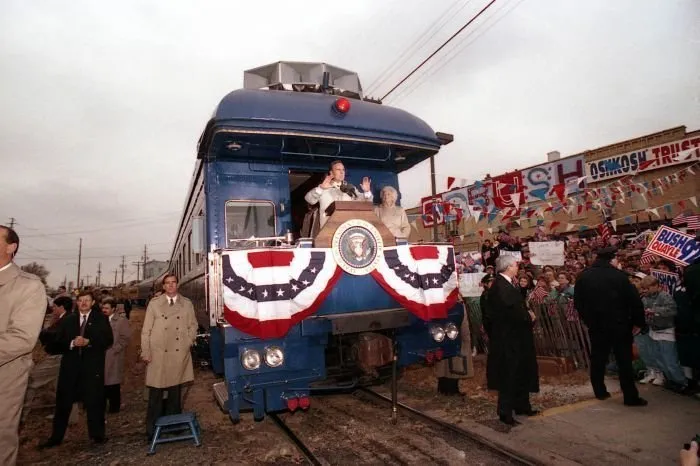 President Bush addresses supporters in Oshkosh, WI as Barbara Bush looks on