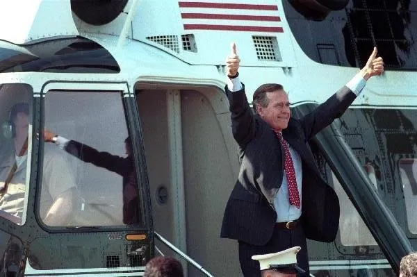 President Bush gives double thumbs-up gesture as he boards Marine One