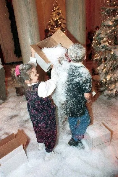 Grandchildren play in artificial snow
