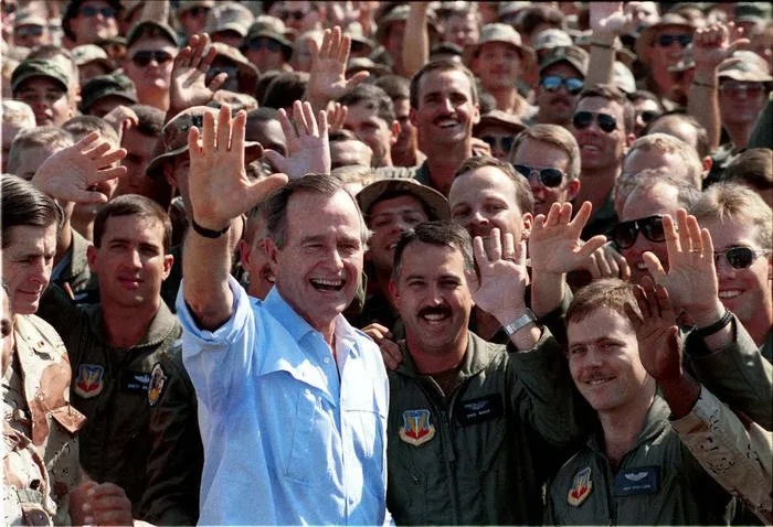President Bush visits with troops in Dharhan, Saudi Arabia during a Thanksgiving visit with the troops
