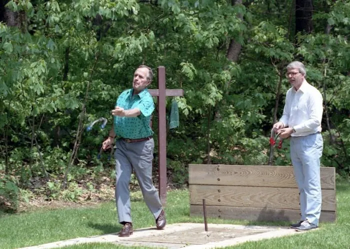 President Bush and PM John Major play horseshoes at Camp David