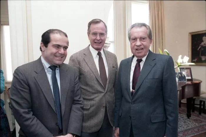 Vice President Bush poses for a photo with Supreme Court Justice Antonin Scalia and Former President Richard Nixon during a party for former special counsel to President Nixon, Dick Moore, held at the VP Residence