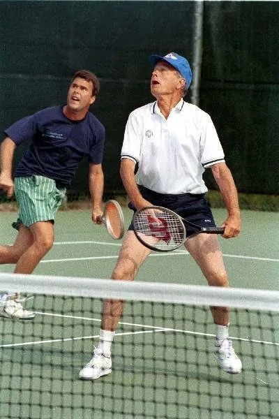 President Bush plays doubles tennis with Jeb