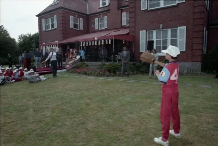 President Bush participates in a Polish Little League Baseball event at the Ambassador's Residence in Warsaw, Poland, and plays catch with one of the boys
