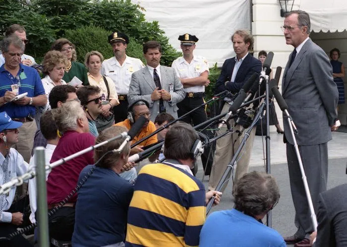 President Bush speaks to the press regarding Iraq's invasion of Kuwait; South Lawn of the White House