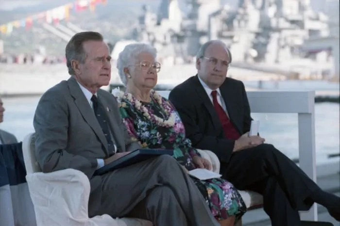President Bush with other dais participants Secretary of Defense Richard Cheney and Pearl Harbor Survivor Lenore Rickert during a ceremony commemorating the 50th anniversary