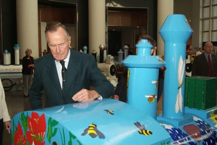 George Bush Signs one of the Miniature Trains Displayed During the "Trains: Tracks of the Iron Horse" Exhibit