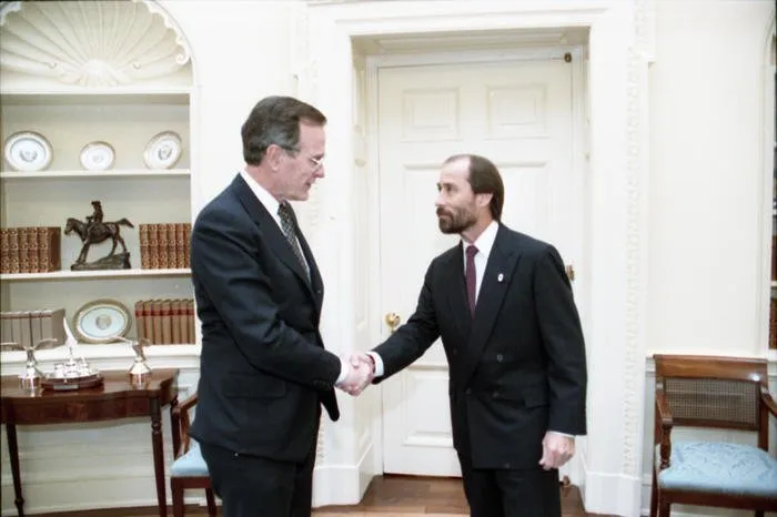 President Bush greets singer Lee Greenwood in the Oval Office