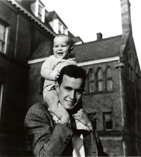 George W. Bush sits on his father's shoulders in New Haven, CT