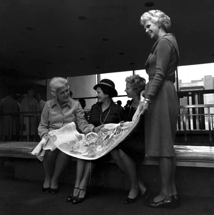 Barbara Bush and Friends Examine a Section of Needlepoint Rug she is Making